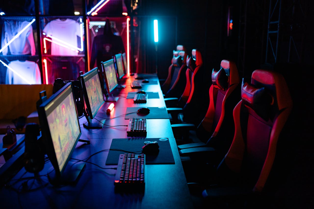 Home High-tech gaming setup with PCs, RGB lighting, and gaming chairs in a gaming house.